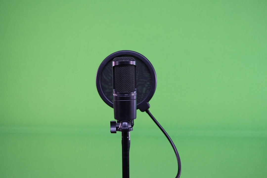 Close up of a professional microphone in a recording booth with warm lighting